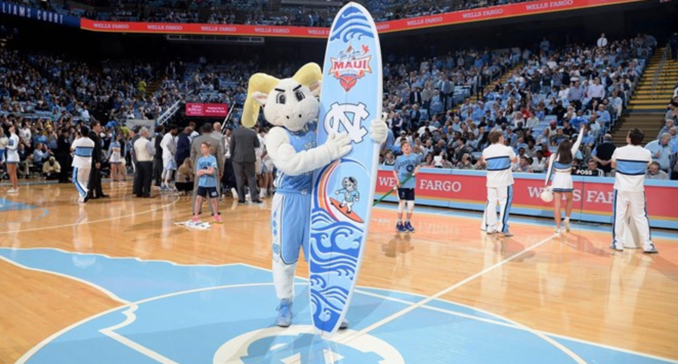 Ramses holding a surfboard at the Dean Dome